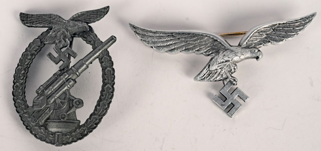 WWII NAZI GERMAN LUFTWAFFE INSIGNIA LOT FLAK BADGE: WWII Nazi German Luftwaffe insignia lot to include 1) LUFTWAFFE FLAK ARTILLERY WAR BADGE. Two piece, die struck zinc construction, solid backed badge is in the form of a vertically oval, oak-leaf wrea