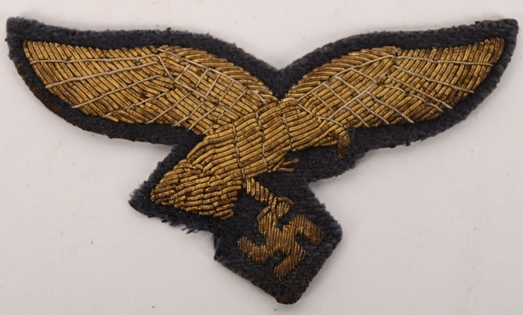 WWII NAZI GERMAN LUFTWAFFE GENERAL'S BREAST EAGLE: Nice quality, hand embroidered, second pattern Luftwaffe eagle in gilt bullion wire with golden/tan accent threads on a cut-out Luftwaffe blue/grey wool base. Hard to find! The Luftwaffe pattern natio