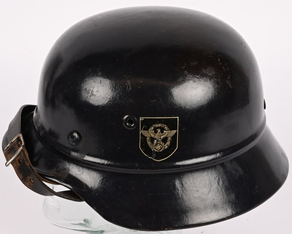 WWII NAZI GERMAN POLICE DD BEADED M40 HELMET WW2: Stamped sheet steel construction M40 style helmet with the addition of an embossed horizontal "bead" positioned at the apex of the front and rear visors and crown. Second pattern, unbordered Police ea