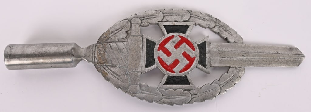 WWII NAZI GERMAN NSKOV POLE TOP WW2: Constructed of aluminum, consisting of a double sided Cross Pattée bearing a central mobile swastika, as the centrepiece of a sword surrounded by an oval oak leaf wreath, set onto a base with dua