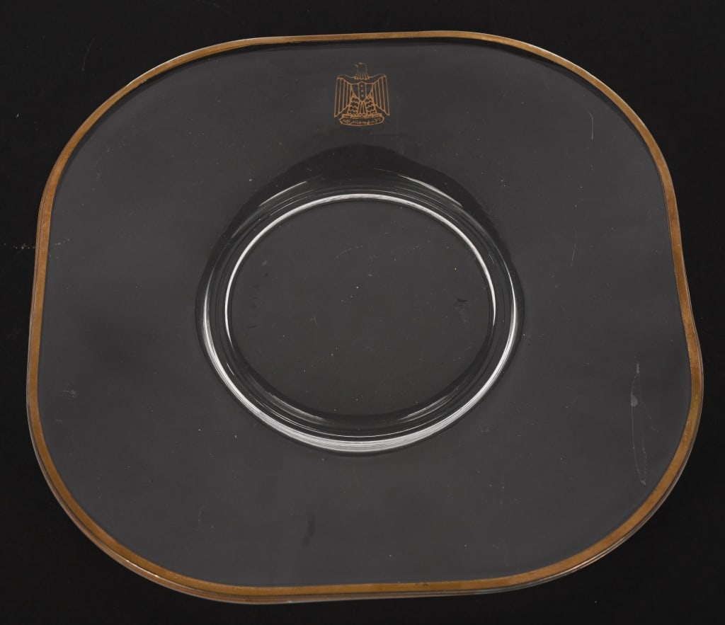 IRAQ WAR SADDAM HUSSEIN GLASS PLATE WITH CREST: During the invasion of Iraq in 2003, U.S. soldiers captured and occupied Saddam Hussein's palaces. Much of the State Silver was taken by soldiers as "spoils of war" and brought back to the United Stat