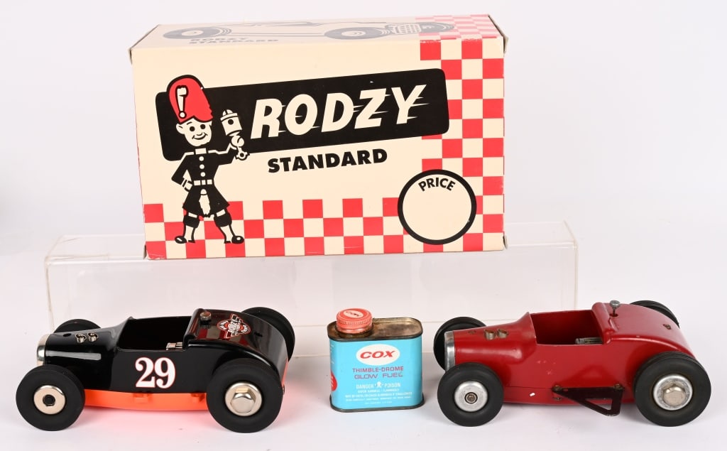 2- RODZY TETHER CARS: One original and one Limited Edition Remake in Box. Both in great shape. Comes with can of Cox Glow Fuel. 8" Excellent Provenance: Tar Heel Toys the Dennis Sapp Collection