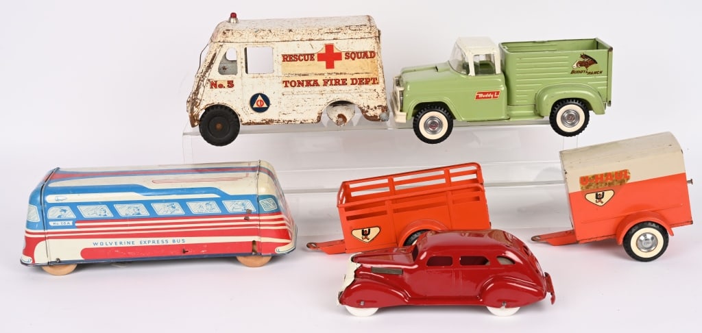 LOT OF PRESSED STEEL TOYS: Includes Tonka Rescue Squad, Buddy L Farm Truck, Wolverine Bus, U-Haul Trailers, and More. Conditions vary. Largest 13" AS-IS Provenance: Tar Heel Toys the Dennis Sapp Collection