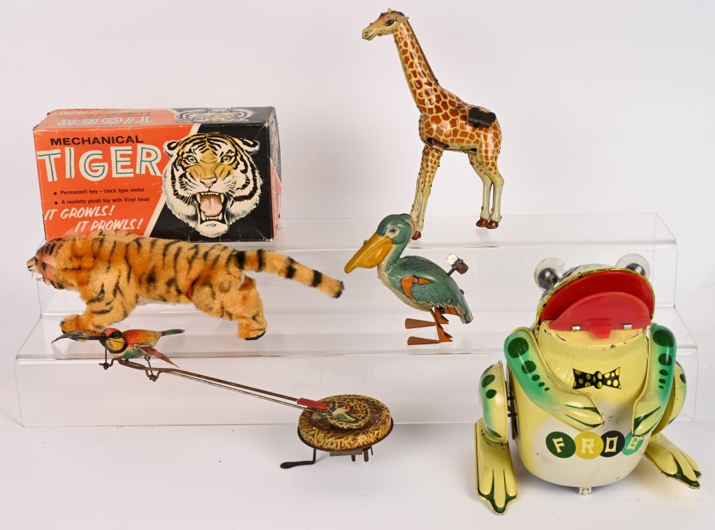 LOT OF VINTAGE ANIMAL TOYS: Includes Marx Tiger in Box, Japan battery operated Frog, German tin windup Stork, Chein Pelican, and Japan Giraffe. All in great shape. Largest 9" Excellent