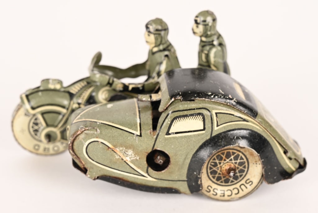 GERMAN TIN WINDUP MILITARY MOTORCYLE w/ SIDECAR: Great looking German tin windup Military Motorcycle with 2 riders and side car. Great colors and details. Works. Has some normal wear. 3 1/2" Excellent