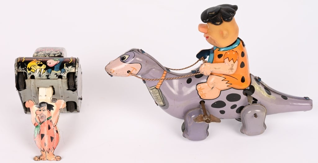 LINEMAR FLINTSTONE ROLL-OVER TANK & FRED ON DINO: Lot includes an all original and complete with Flintstone Roll-Over tank and Fred is on bottom. Has nice Flintstone graphics. Windup works. 4" Excellent. Also a Linemar tin windup Fred Flintstone on