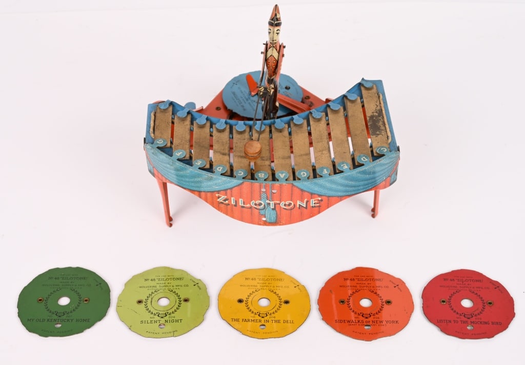 WOLVERINE TIN WINDUP ZILOTONE w/ RECORDS: All original in nice condition. Works and plays music. Comes with 6 Records. There is some wear on the keys. 9" Excellent