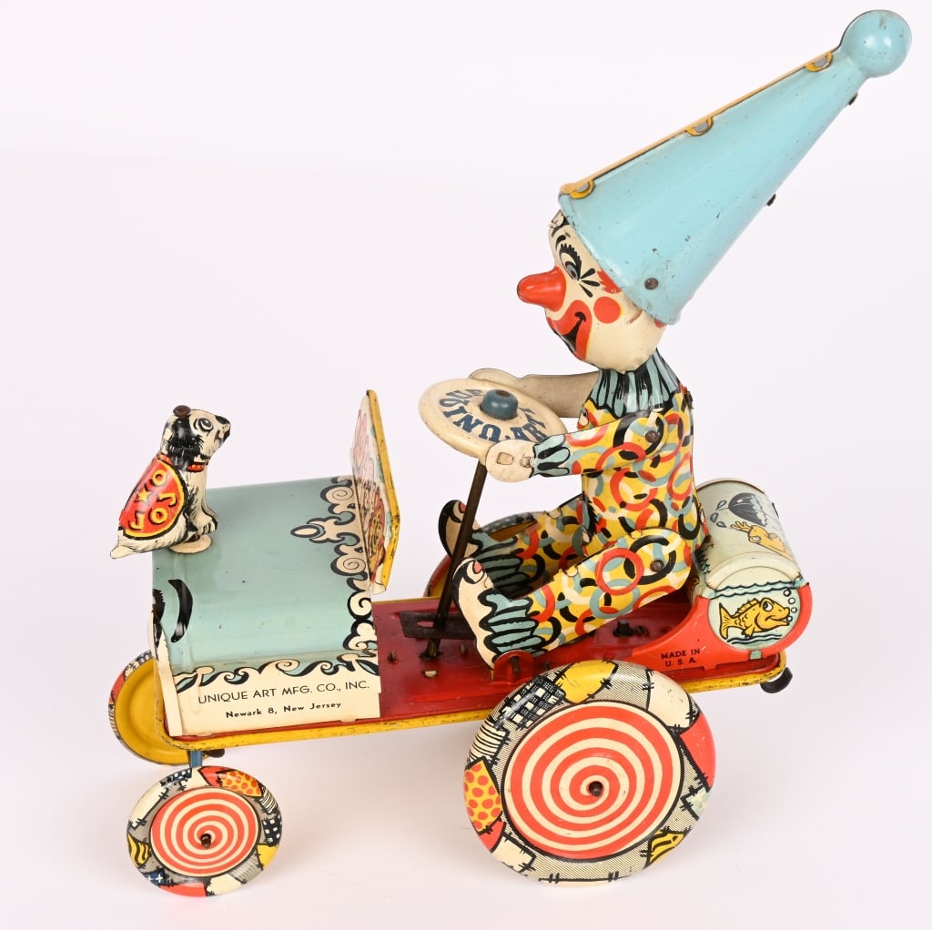 UNIQUE ART TIN WINDUP ARTIE THE CLOWN CRAZY CAR: All original and complete. Has very nice colors. Windup works. Missing ears. 8" Excellent