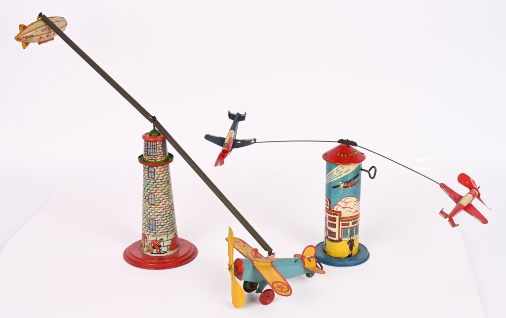 MARX TIN WINDUP SKY FLYER & SKY HAWK: All original and complete with Windup Airplane and Blimp. Works. 24" Excellent. All original and complete. Works. The celluloid propellers have splits in them. Tower measures 7 1/2" Very Good