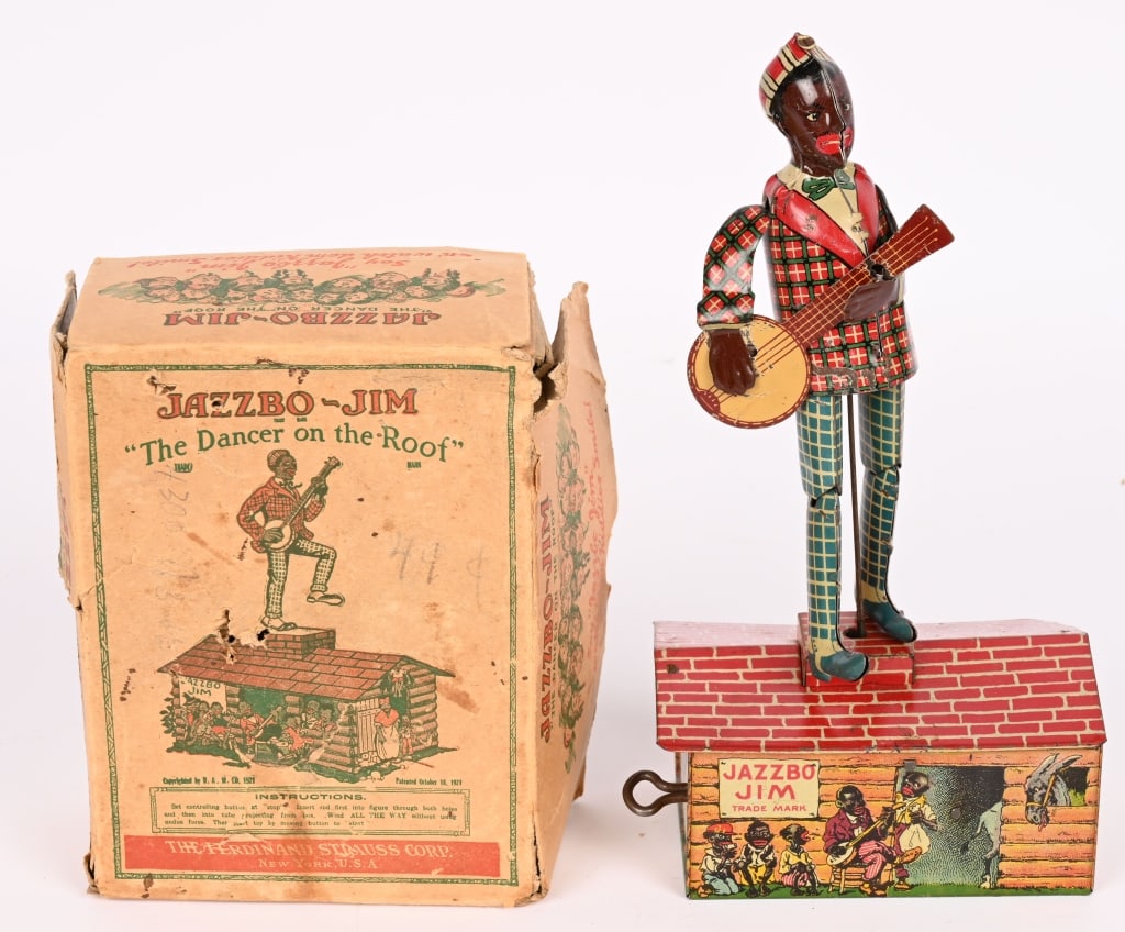 STRAUSS TIN WINDUP JAZZBO JIM w/ BOX: Complete and original with bright graphics and gloss. Worked well when tested. Original box has wear. 9 1/2" Excellent