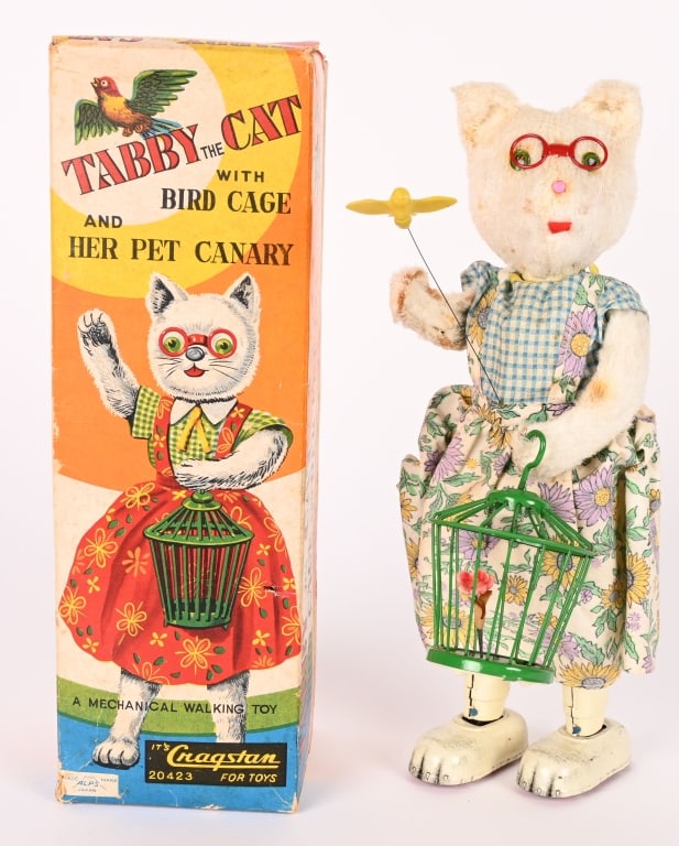JAPAN TIN WINDUP TABBY THE CAT & BIRD CAGE w/ BOX: Great action toy has Tabby holding her bird cage while her pet canary flutters inn front of her. Makes a bird sound. Windup works. Minor soiling. Great looking colorful box. 10" Excellent