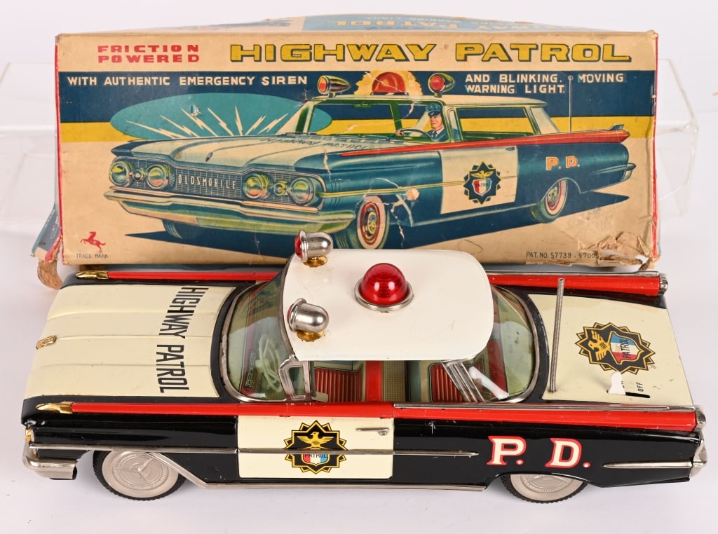 JAPAN TIN FRICTION OLDSMOBILE HIGHWAY PATROL CAR: All original in great shape. Friction drive with electric lights. Grat condition. Works. With partial Box. 13" Excellent