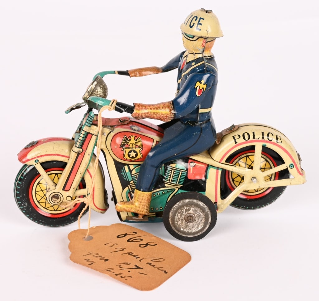 JAPAN TIN FRICTION POLICE MOTORCYCLE: All original with nice details. Friction works. Still has a store tag on the bike. 4 1/2" Excellent