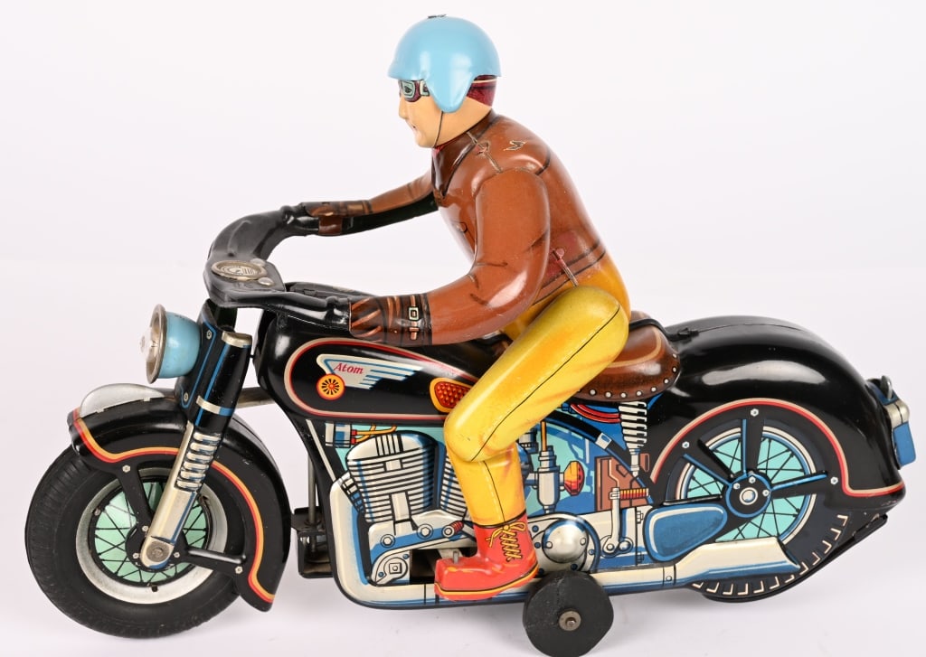 JAPAN BATTERY OP ATOM MOTORCYCLE: Japan battery operated Atom Motorcycle. Large toy where rider gets on and off. All original in great shape. Worked when tested. 12" Excellent