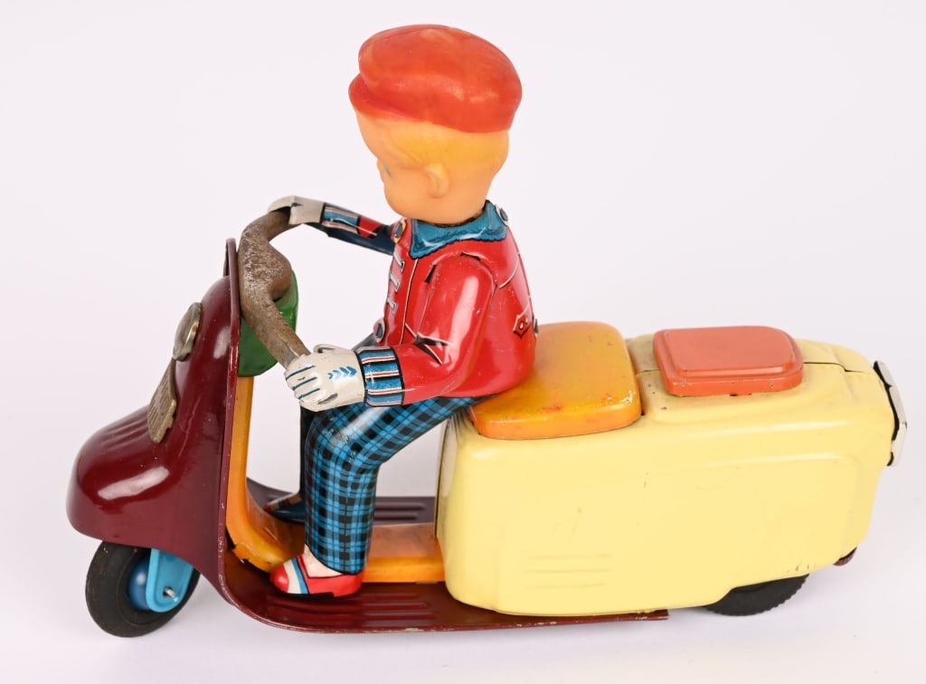 JAPAN TIN FRICTION BOY ON SCOOTER: All original with tin rider with vinyl head. Friciton works. Nice condition. 7 1/2" Excellent