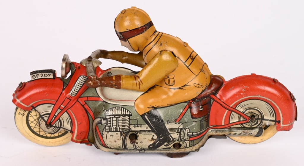 GERMAN FISCHER TIN WINDUP MOTORCYCLE: German motorcycle marked GF 207. Very detailed motorcycle toy that worked when tested. Changes directions as it goes. No key is included. 5" Excellent