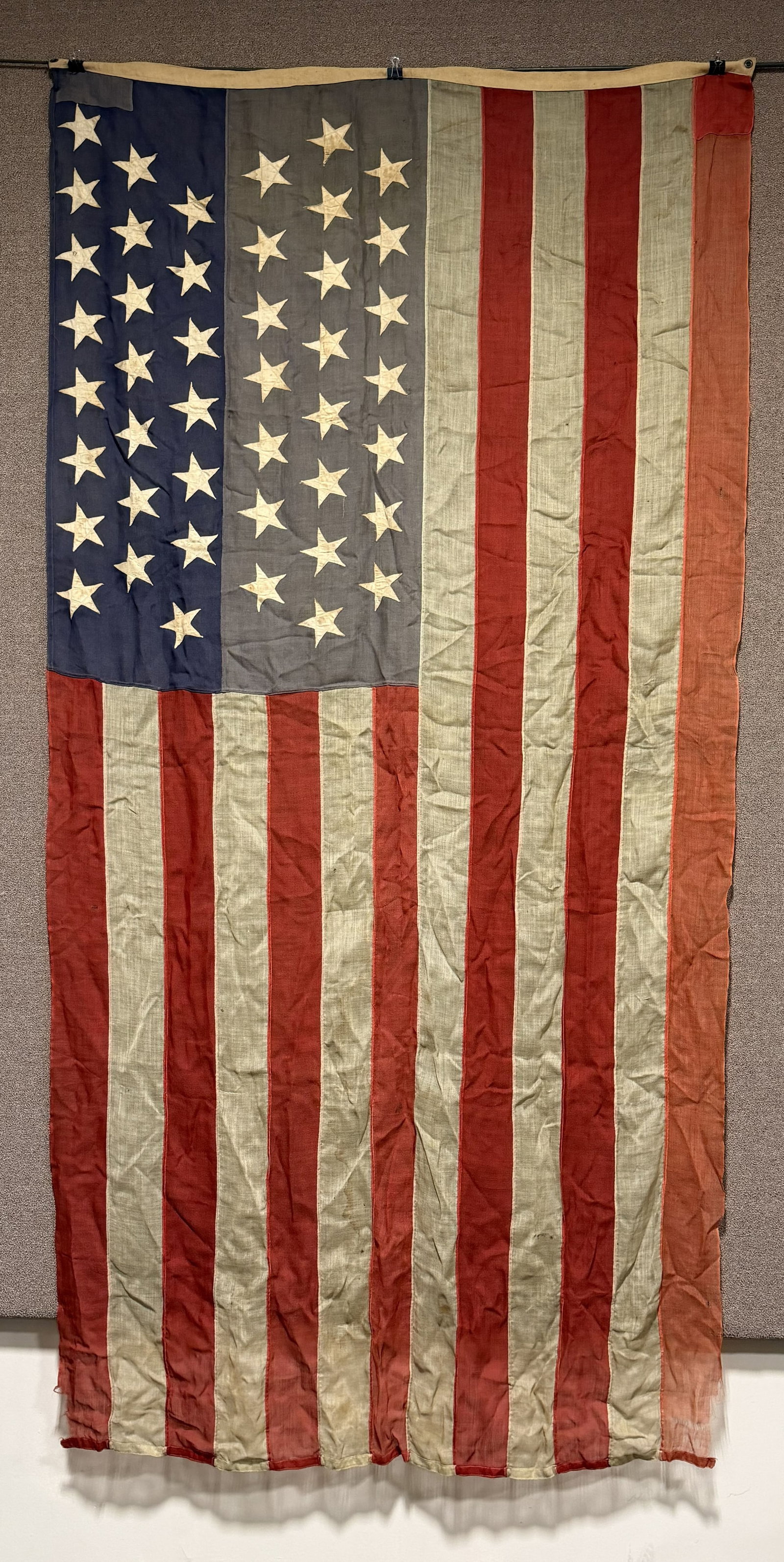 US 44 STAR FLAG WITH DEDICATION 123rd OVI GAR: 44 Star American Flag measuring 58 X 112 inches with a dedication to the bunting that reads " Presented to A.L. Smith Co. C 123rd Reg. O.V.I. By Crocker. Post. No. 12 G.A.R. Dep. of Iowa. Augustus L. 