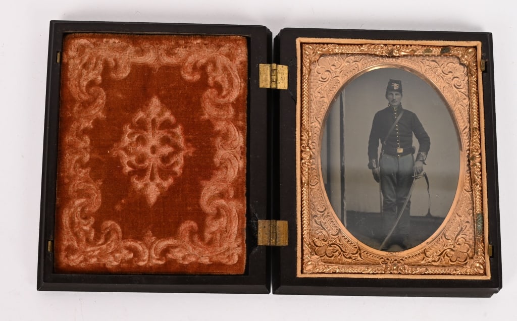 CIVIL WAR CAVALRY QUARTER PLATE ARMED TINTYPE: A beautiful Quarter Plate Civil War Cavalryman Tintype in a fine Gutta percha Case A very young Cavalryman wearing a Kepi that is adorned with his Cavalry Troop Number and A Company. The top of the ca