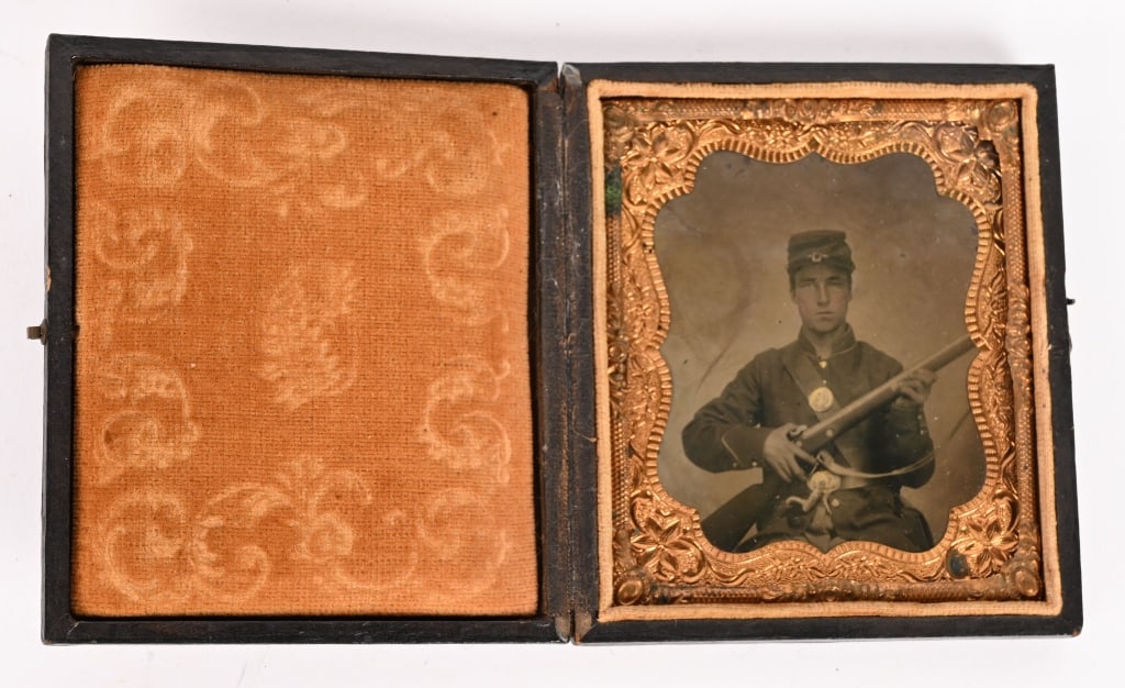 CIVIL WAR ARMED INFANTRY W M1861 RIFLE & SLING: A well Armed Sixth Plate Civil War Infantry Seated Soldier holding a M1861 Rifle with Sling. The Bayonet for the weapon is on his belt, housed in the leather scabbard. The soldier is wearing his Kepi 