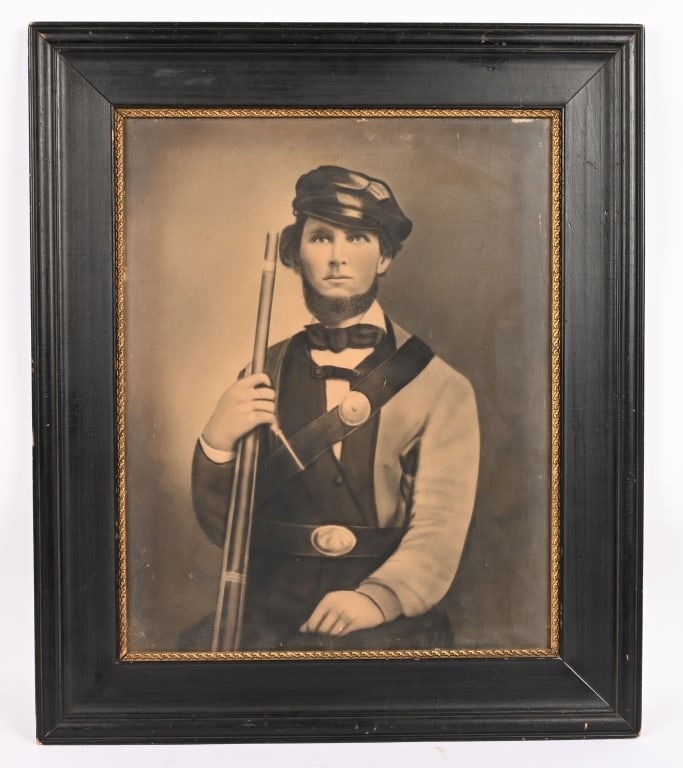 CIVIL WAR CONFEDERATE ARMED FRAMED IMAGE: Framed Civil War image of a Confederate measuring 22 1/2 X 26 1/2 inches in total with an image of a soldier holding a Musket with a Cartridge Box and a State Belt Buckle. Excellent.