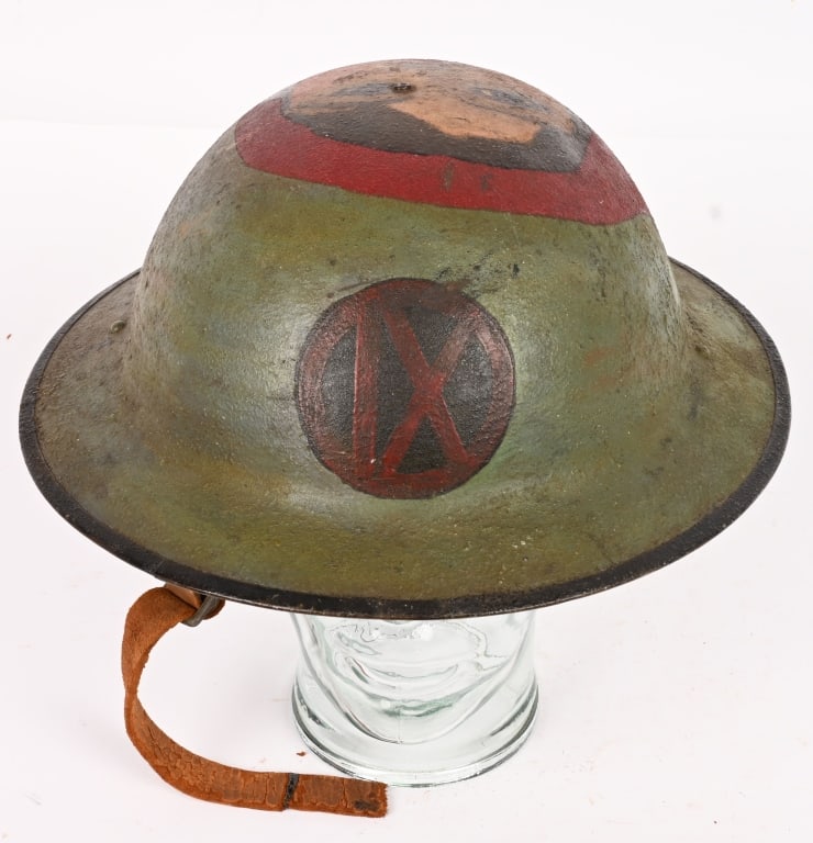 WW1 US ARMY IX CORPS PAINTED HELMET W LADY'S FACE: WWI IX Corps Painted Helmet with liner and chinstrap. This top shelf painted helmet has a portrait of a lady to its top. To the front of the helmet is the insignia of the IX Corps. Chinstrap has a cou
