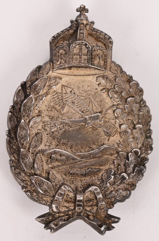 IMPERIAL GERMAN PRUSSIAN PILOTS BADGE BY JUNCKER: Badge in solid silver, by Juncker, nicely maker marked and silver hallmarked "C.E. Juncker Berlin 800"; hollow construction with pierced crown, of very fine quality with fine details, slightly worn,