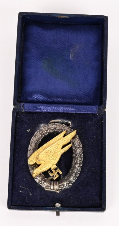 WWII NAZI GERMAN LUFTWAFFE PARATROOPER BADGE OSANG: Luftwaffe Fallschirmjäger Badge by G.H Osang of Dresden. A fine early quality manufacture example of a Paratrooper/Fallschrimjäger badge; in gilded and silvered tombac, needle style vertical