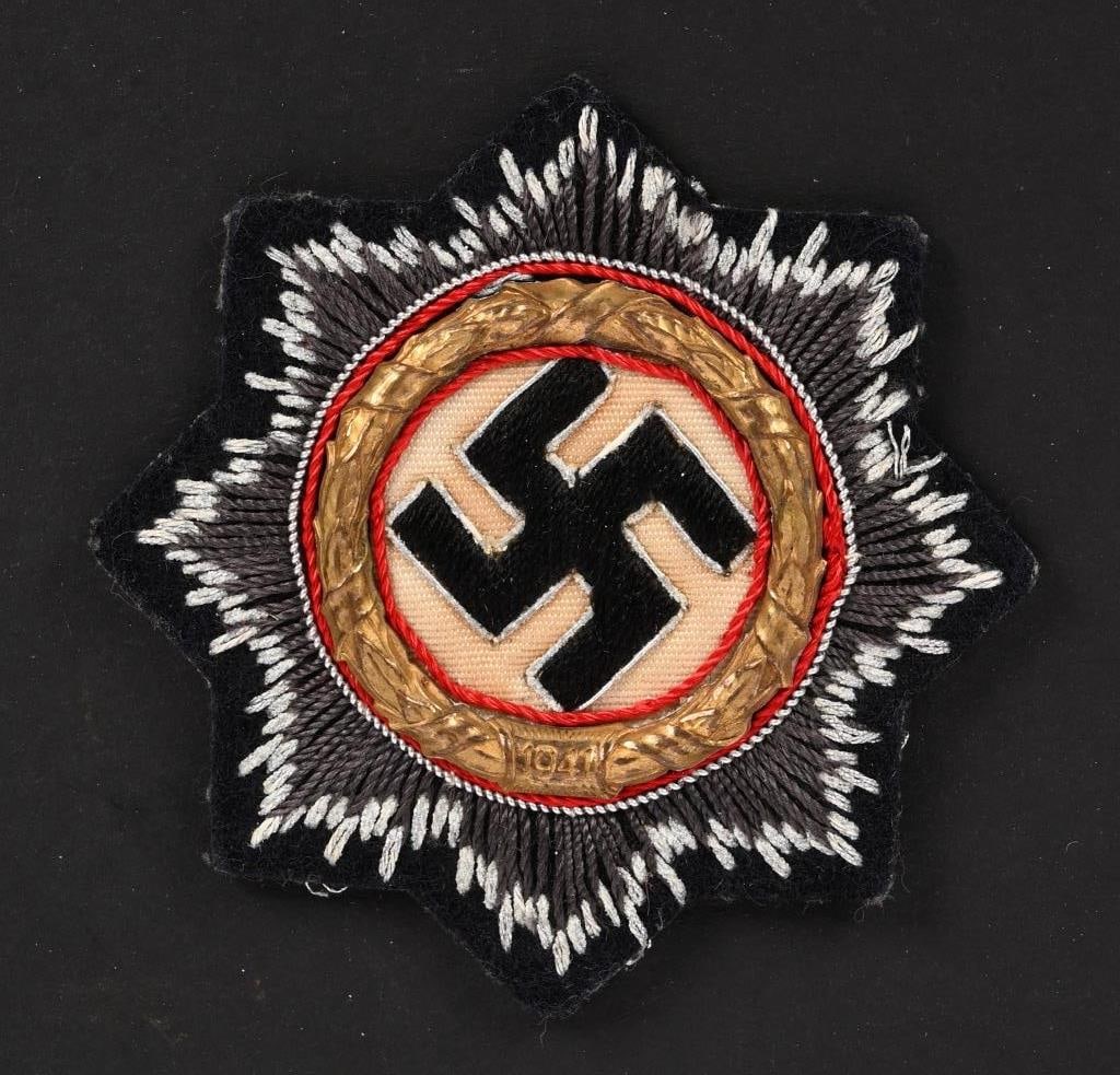WWII NAZI GERMAN CROSS IN GOLD FOR PANZER TROOPS: Hand embroidered example features a double, overlaid, eight point, sunburst pattern with the top, inner layer, sunburst in matte, brownish/gray, cotton threads, and the bottom, outer layer, in bright,