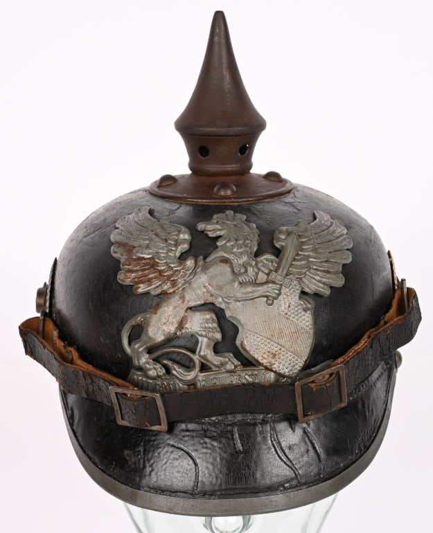 WW1 IMPERIAL GERMAN SPIKED HELMET EM BADEN WWI: Model 1915 Baden Infantry regimentally marked J.R. 111 Pickelhaube. Original helmet plate, cockades and spike with chinstrap with a couple of old repairs and with a complete liner. Roughly a size 57. 
