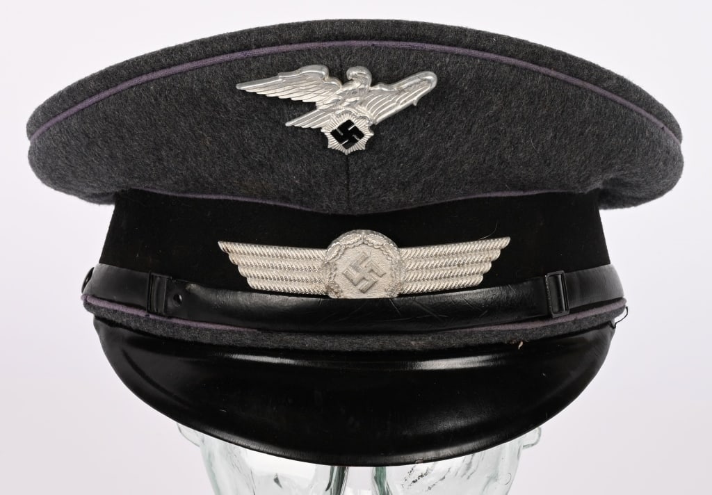 WWII NAZI GERMAN RLB ENLISTED VISOR CAP WW2: Second pattern officer’s visor cap was introduced in 1938. Nice quality, private purchase, Luftwaffe blue/gray wool/rayon blend construction cap with a whipcord weave and a black wool centerband