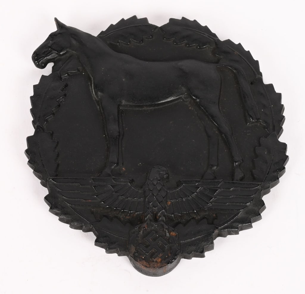 WWII NAZI GERMAN PLAQUE FOR DONATION OF HORSES WW2: A heavy, black iron award in the form of a 11cm diameter oak leaf wreath which, to the obverse, mostly encircles a profiled horse, standing atop a spread-winged eagle with a wreathed, mobile swastika 