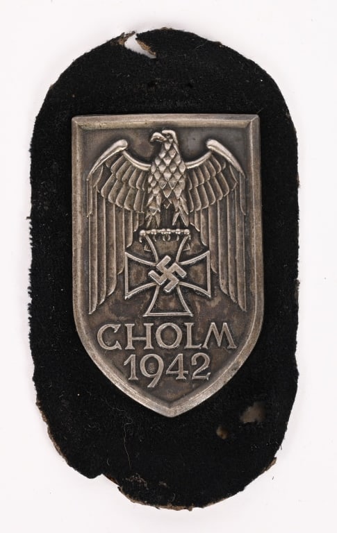 WWII NAZI GERMAN CHOLM CAMPAIGN SHIELD WW2: Cholm Shield Sleeve Badge. Magnetic steel on black wool construction that has minor mothing. The Cholm Campaign Shield was the second of the officially sanctioned campaign shield series and was instit