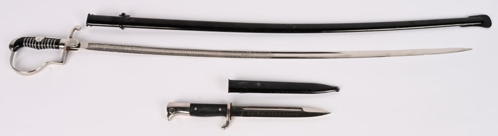 WWII NAZI GERMAN ENGRAVED BLADE SWORD 13TH CAVALRY: Wehrmacht Heer (WH) Artillery Extra Saber for Enlisted Men, with Blade Etching “Kavallerie-Regiment Nr. 13, Lüneburg”Nickel-plated hilt with simple knuckle bow and black plastic grip,