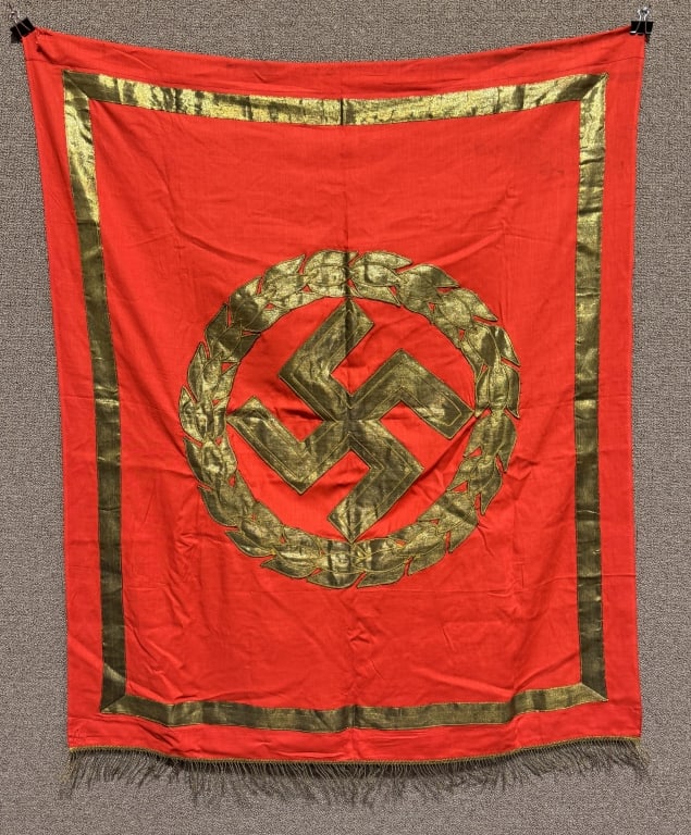 WWII NAZI GERMAN NSDAP POLITICAL PODIUM BANNER WW2: An exquisite 40 X 47 inches excluding fringe is a single sided multi-piece cotton/rayon construction banner featuring a red base field with a separate gold wreath bullion canted swastika. The border o