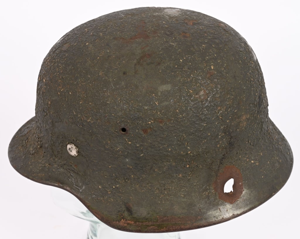 WWII NAZI GERMAN ZIMMERIT CAMO PAINTED HELMET WW2: This bullet stuck helmet is stamped, sheet steel construction helmet has been repainted with thick Zimmerit Green Camo Paint. All three liner retaining rivets and both inserted ventilation bushi