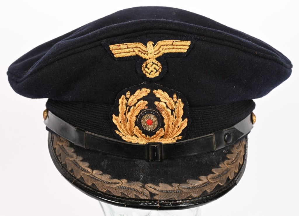 WWII NAZI GERMAN KRIEGSMARINE CAPTAIN'S VISOR HAT: Post-May 1936 pattern, Field/Staff grade Officer’s visor cap with a black horizontally ribbed mohair centerband, slipped over a deep navy blue wool body and a non removable blue top. The front c