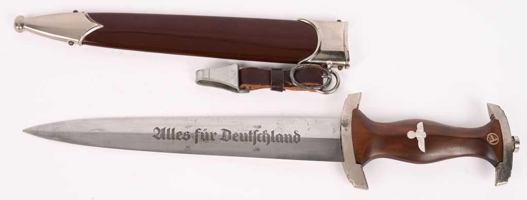 WWII NAZI GERMAN SA DAGGER RZM 7/42 WKC MINT: SA dagger with a 22cm long double-edged drop-forged nickel-silver plated blade in its original scabbard. The dagger has a cast pommel and tang nut. Its contoured wooden grip has inlaid to its obverse 