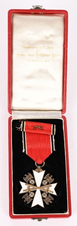 WWII NAZI GERMAN EAGLE ORDER 5TH CLASS W SWORDS: 1943 pattern, die struck, 5th class award, with white enamel work and fired gilt finish. Award in the form of a 45mm square, Maltese cross with white enamel arms. A gilt eagle with down swept wings, c