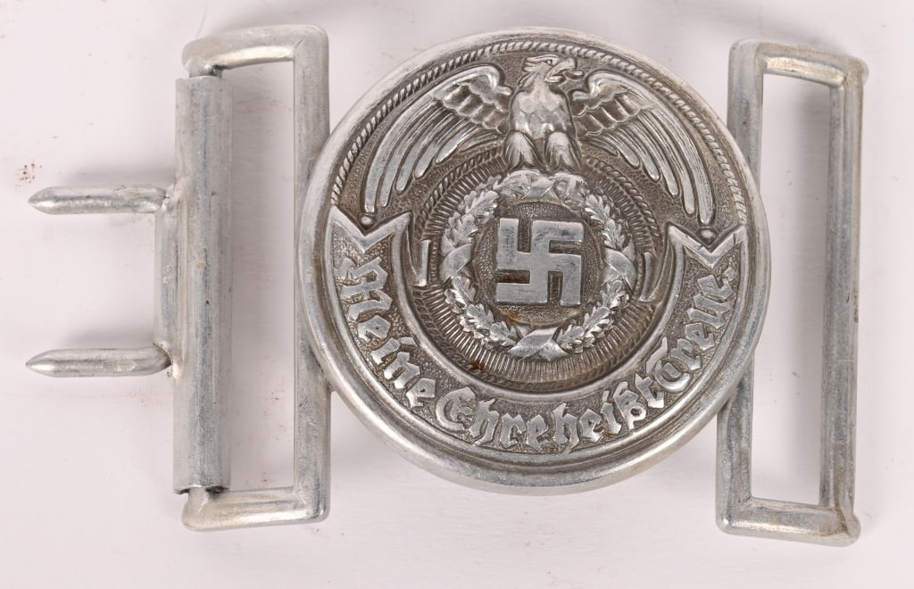 WWII NAZI GERMAN SS OFFICER'S BELT BUCKLE BY oLc: Die struck, silver washed, aluminum construction circular buckle. The buckle features a high relief stylized national eagle with outstretched, downward curving, wings clutching an oak-leaf wreath whic