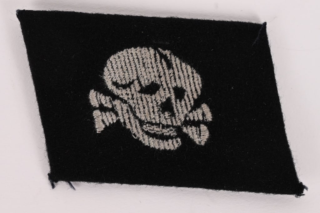 WAFFEN SS TOTENKOPF BEVO COLLAR TAB W RZM TAG: Extremely rare and highly desirable Waffen-SS enlisted man’s collar tab of the SS-Totenkopf Division. Unlike the officer-grade examples woven in silver flatwire, this is the scarcer enlisted con