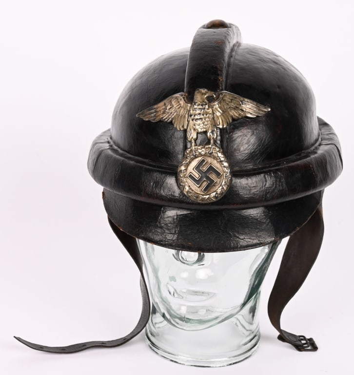 WWII NAZI GERMAN NSKK LEATHER CRASH HELMET WW2: Molded, smooth, blackened leather helmet with raised, padded, protective bars running horizontally around the helmets bottom edge, and another one running from front to back over the crown top. Helmet