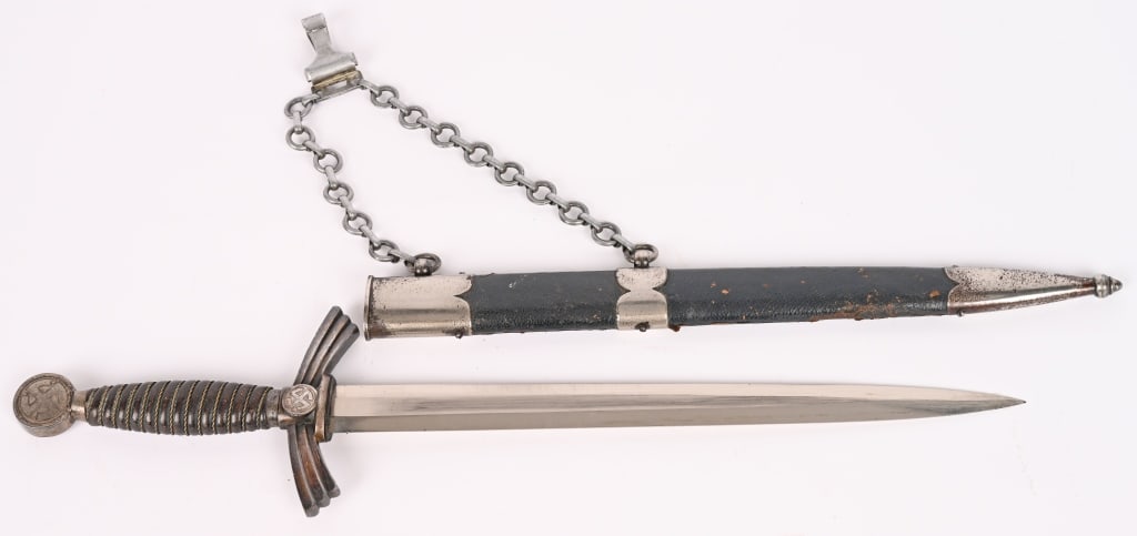 WWII NAZI GERMAN 1st MODEL LUFTWAFFE DAGGER WW2: Early (circa 1936-1937) roughly 30.5cm long bright nickel/silver plated drop forged steel double edged stiletto style blade with a flat central plane. The original pebbled, blue leather washer is inta