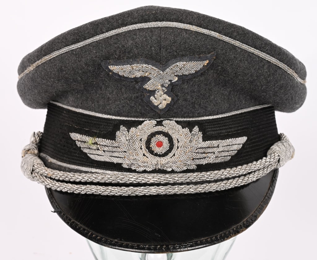 WWII NAZI GERMAN LUFTWAFFE OFFICERS VISOR HAT WW2: Luftwaffe blue/gray, wool/rayon blend construction visor cap with a very subtle, whipcord weave features a black, horizontally ribbed, interwoven, mohair centerband, and bright, interwoven silver/alum
