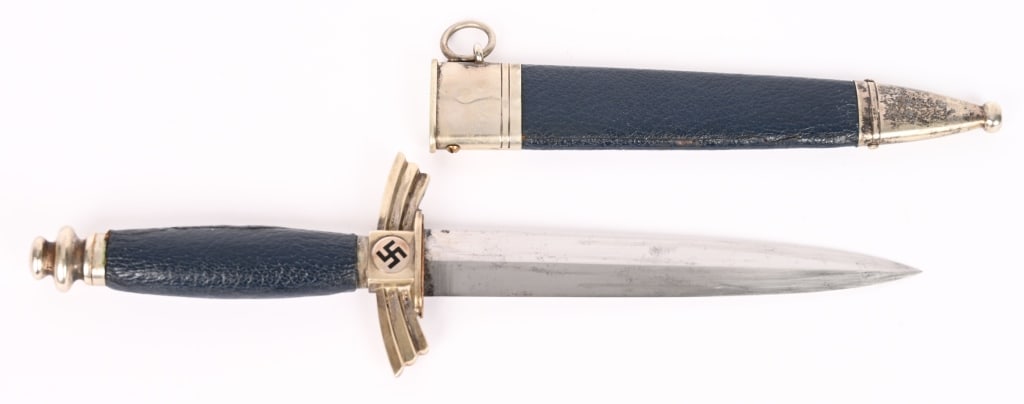 WWII NAZI GERMAN DLV DAGGER SMF w/ SCABBARD WW2: DLV glider pilot’s dagger. The 17cm long silver/nickel plated blade is in excellent condition, marked "SMF". Solid nickel/silver cross guard and pommel. Black enameled swastika to both sides of 