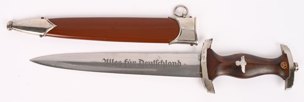 WWII NAZI GERMAN SA DAGGER RZM 7/42 WKC WW2: SA dagger with a 22cm long double-edged drop-forged nickel-silver plated blade in its original scabbard. The dagger has a cast pommel and tang nut. Its contoured wooden grip has inlaid to its obverse 