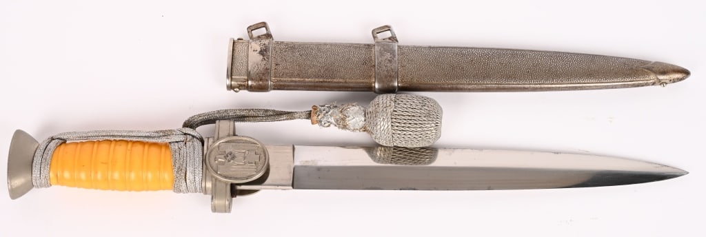 WWII NAZI GERMAN RED CROSS DAGGER & SCABBARD WW2: Roughly 25cm long, dual edged, nickel/silver plated, drop forged steel blade with a raised central spine and large flat ricasso. The blade is unmarked. The cast alloy cross guard, langets, and pommel