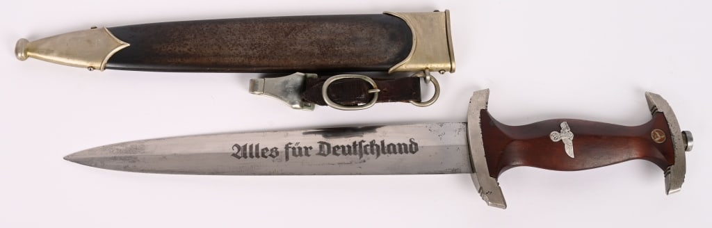 WWII NAZI GERMAN NSKK DAGGER BY PUMA w/ SCABBARD: NSKK dagger with a 22cm long double-edged drop-forged nickel-silver plated blade in its original scabbard. The dagger has a cast nickel-silver plated pommel and tang nut. Its contoured wooden grip
