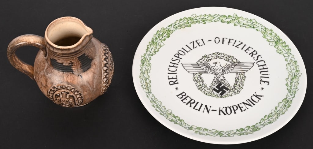 WWII NAZI GERMAN POLICE PLATE & DDAC WINE KRUG WW2: WWII Nazi German lot to include 1) REICHSPOLIZEI OFFIZIERSCHULE BERLIN KÖPENICK PLATE. Measures 9.5 inches, possible makers mark lower reverse, damage and crazing free. 2) WWII NAZI 1938 DDAC REI