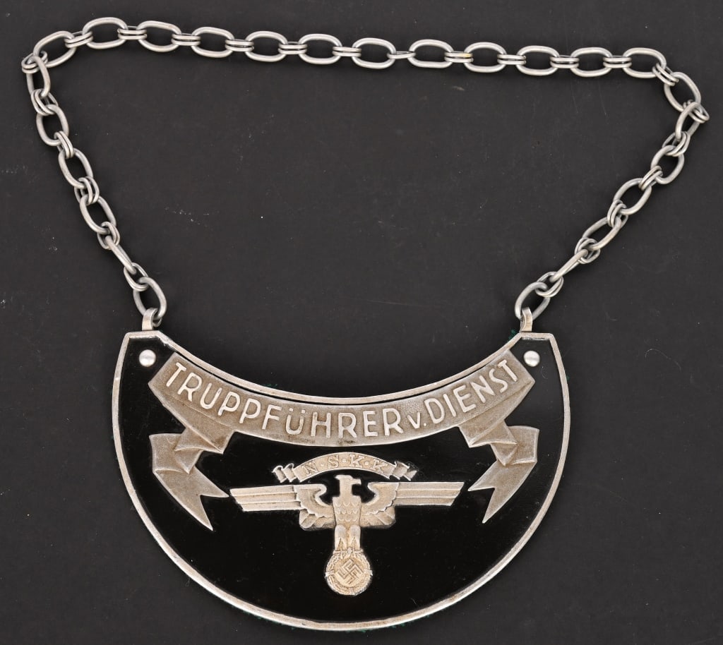 WWII NAZI GERMAN NSKK TRUPPFUHRER V. DIENST GORGET: A scarce NSKK (National Socialist Motor Corps/Nationalsozialistisches Kraftfahrkorps) Truppführer v. Dienst gorget; in Aluminium. On the obverse; raised lettering with “NSKK Truppführe