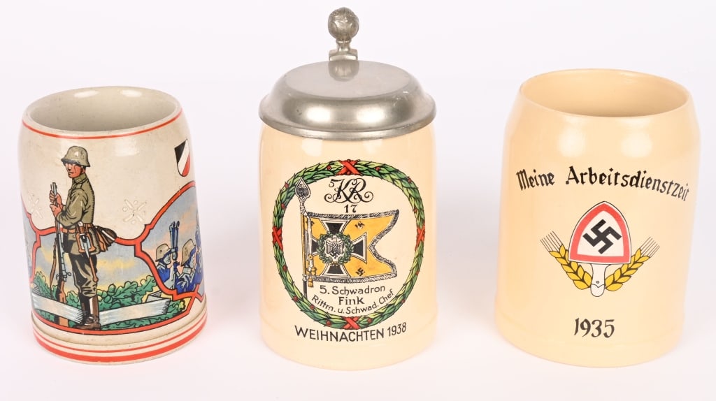 WWII NAZI GERMAN MILITARY STEIN LOT WW2: Lot of 3 Nazi German Military or Paramilitary ceramic Steins to include 1) An untitled Heer Stein showing a Machine Gun Crew and a Artillery Crew sighting in their weapon as Vignettes with aRifleman t